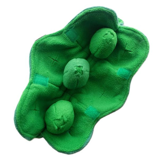 Open view of Squeaky Peas snuffle dog toy showing three plush peas inside green fleece pod