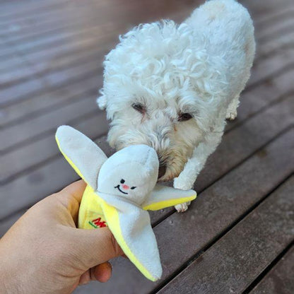 Lily sniffing Banana-Rama Dog Toy