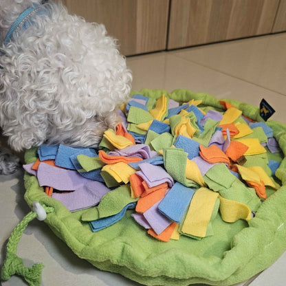 Small dog using Sniff & Stash snuffle mat indoors for calm nosework enrichment