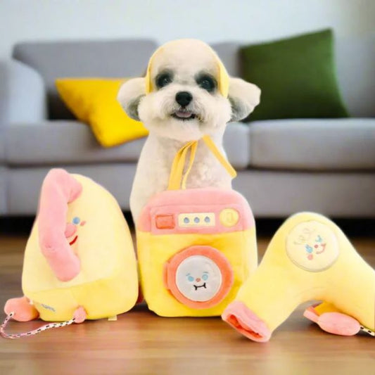 Dog posing with Woof² Housekeeping Series plush toy set including washing machine, iron, and hair dryer