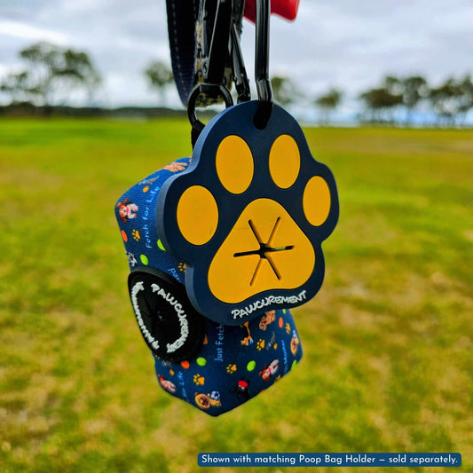 Pawcurement Fetch For Life Poop Bag Carrier shown with matching Poop Bag Holder attached to a leash outdoors – holder sold separately.