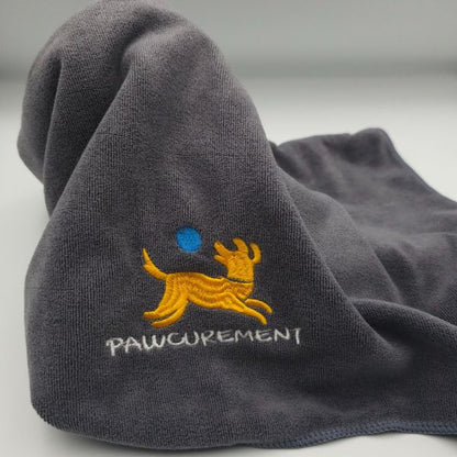 Close-up of Pawcurement quick dry towel showing yellow dog logo and absorbent fabric texture