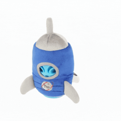 Animated GIF showing the P.L.A.Y. Alien Buddy Starblaster dog toy being unwrapped to reveal the hidden blue alien inside.