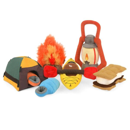 P.L.A.Y. Camp Corbin Collection plush dog toys featuring camping gear designs including tent, kayak, campfire, lantern, and s’mores