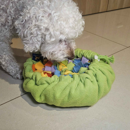 Dog foraging treats on Sniff & Stash snuffle mat spread flat on the floor