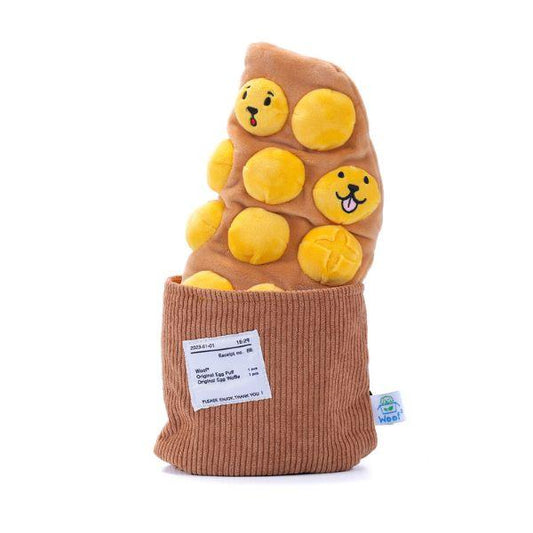 Front view of the Woof² Egg Puff Waffle Nose-work Dog Toy showing egg puff with smiley faces inside the brown removable bag.